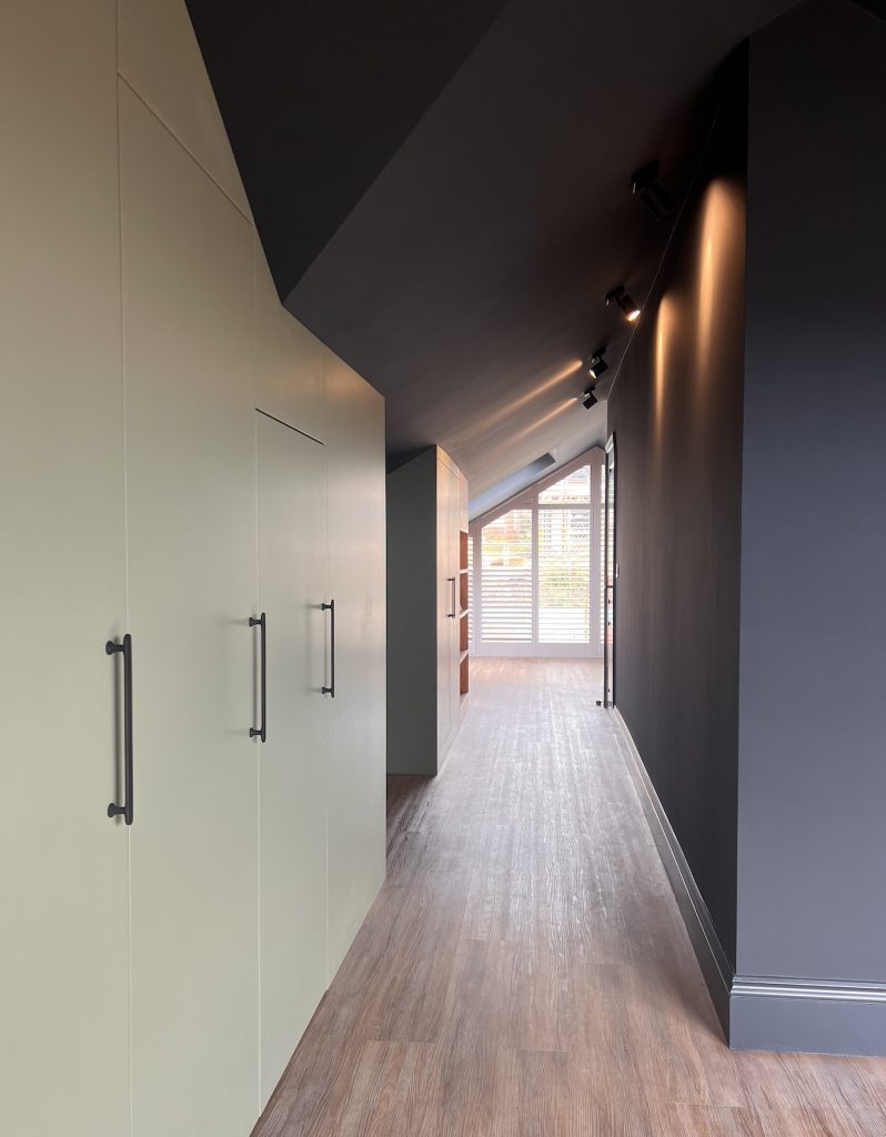 Loft interior with bespoke cabinets painted in Farrow & Ball Pigeon, contrasted by walls and ceilings in Railings.